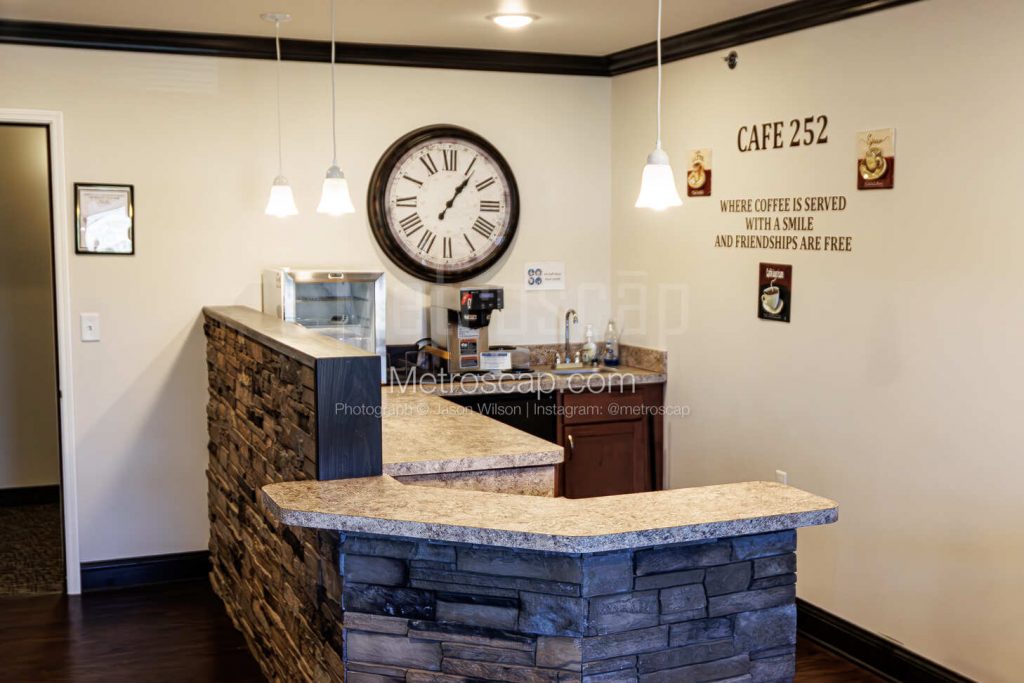 The interior of a community cafe with a stone bar and decorative wall art